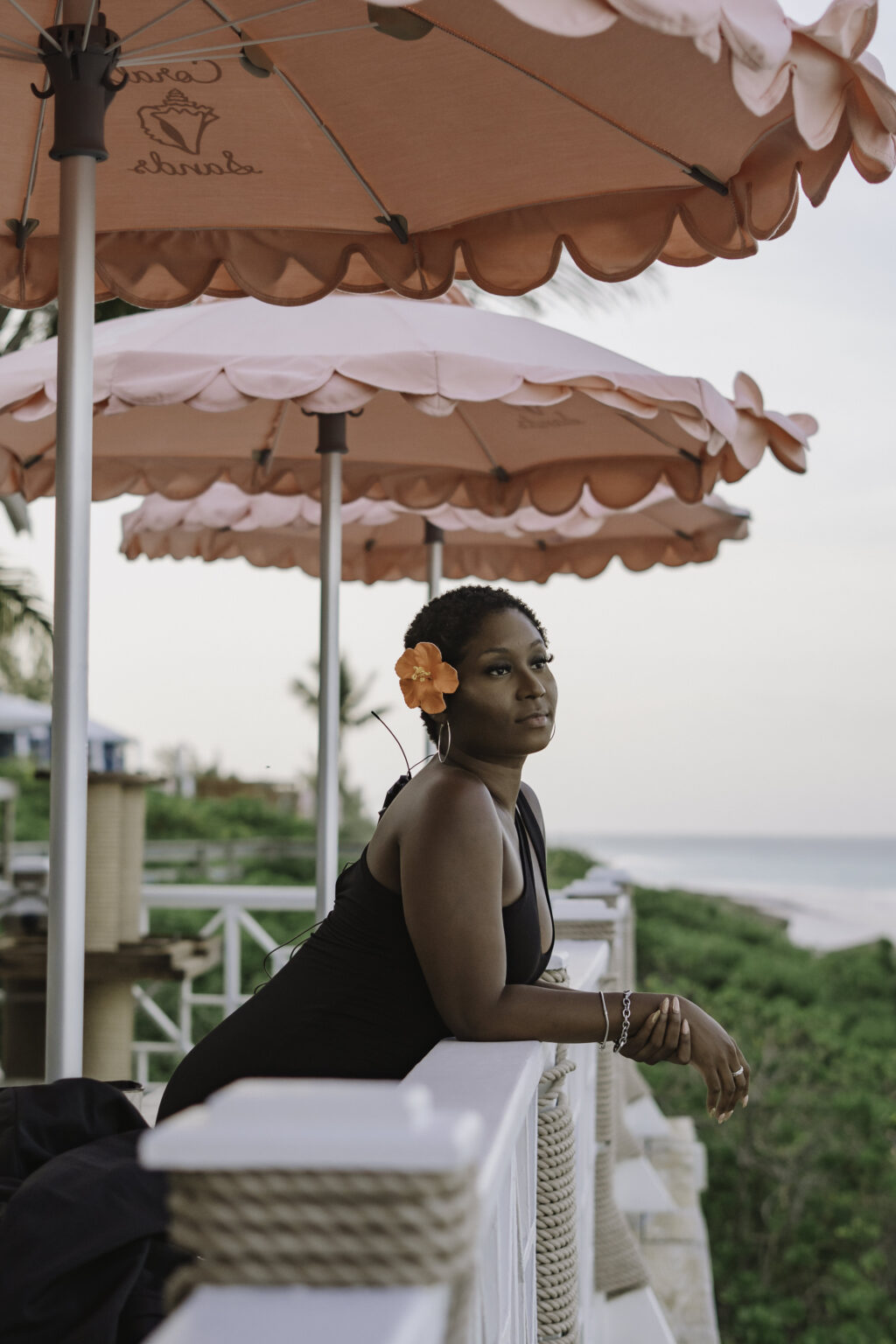 Maradona under pink umbrellas by the sea, your local Bahamas travel concierge