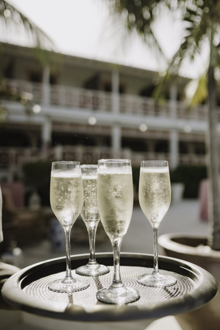 Glasses of champagne on a tray at a Harbour Island resort in The Bahamas