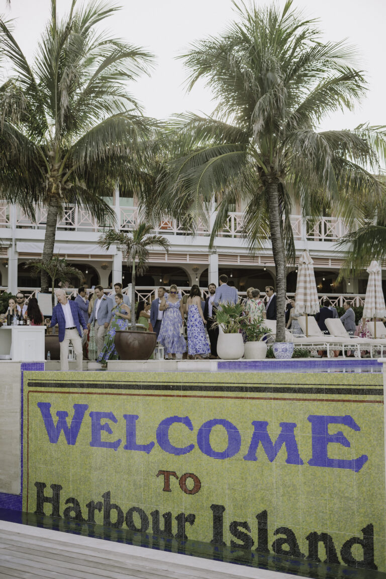 Wedding guests gathered behind the Welcome to Harbour Island sign